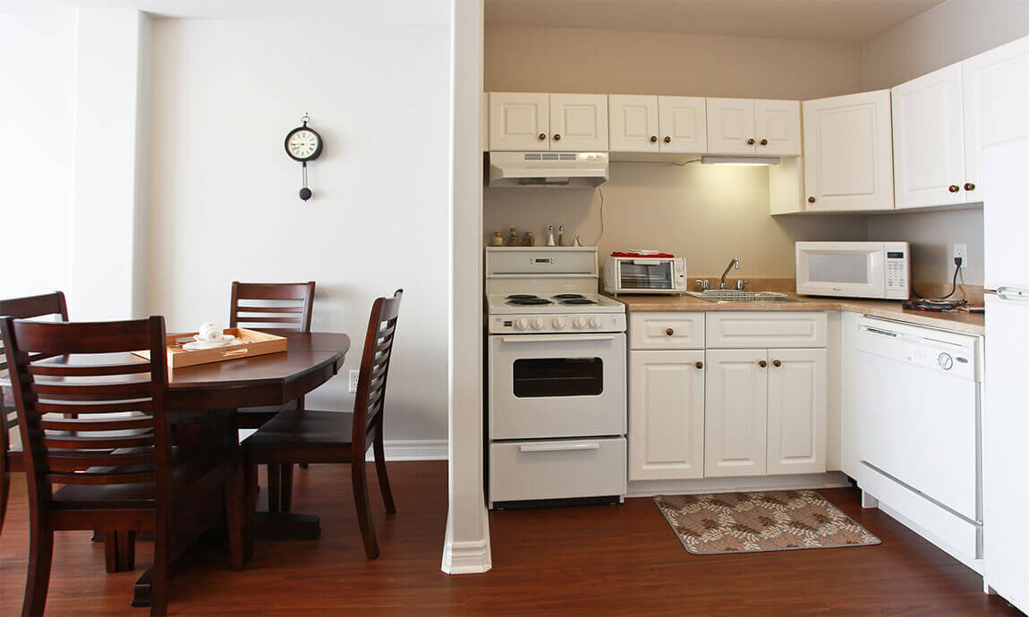 The Dining area of the Suite, with chair and table next to the kitchen space.