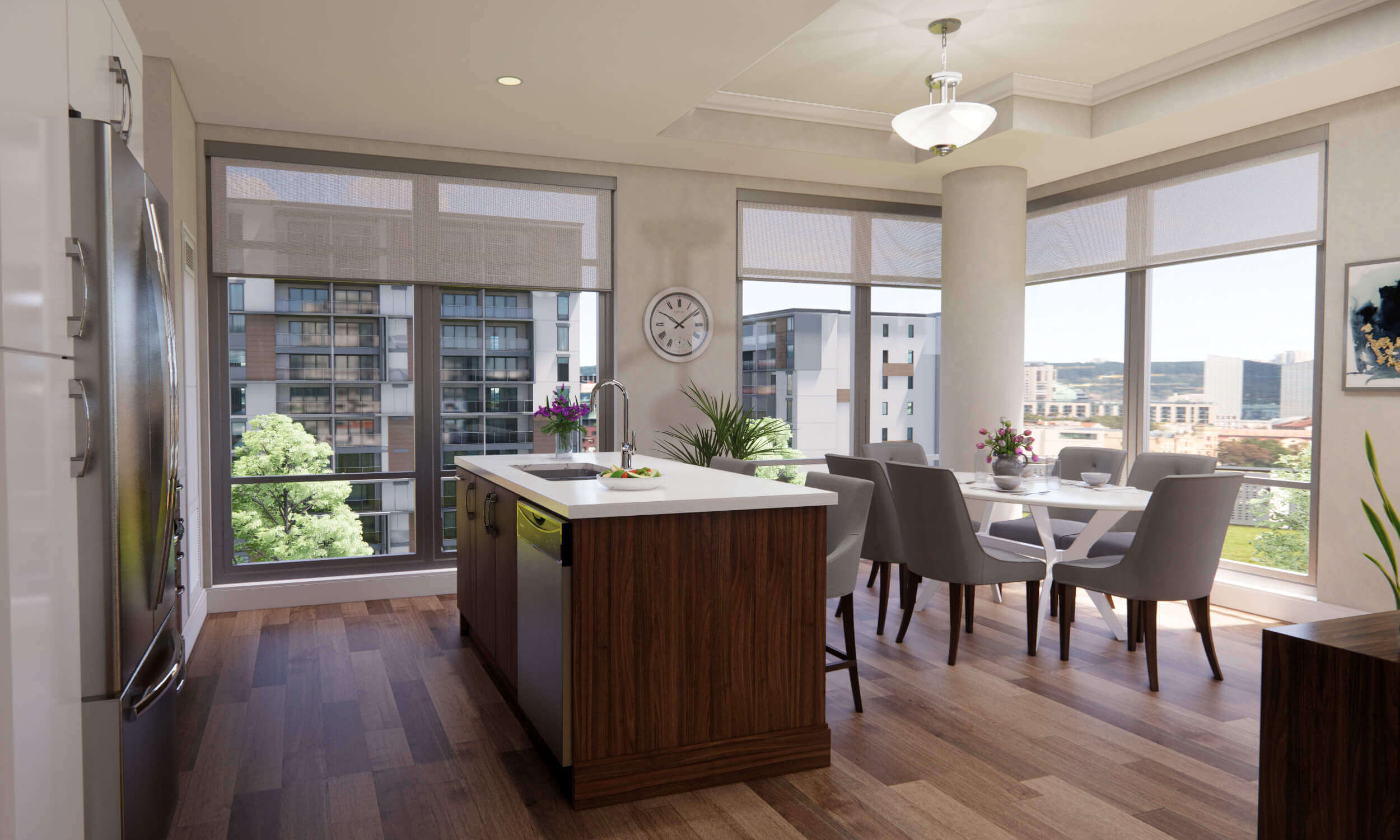 Open-concept kitchen with white and wood island and dining room with grey chairs