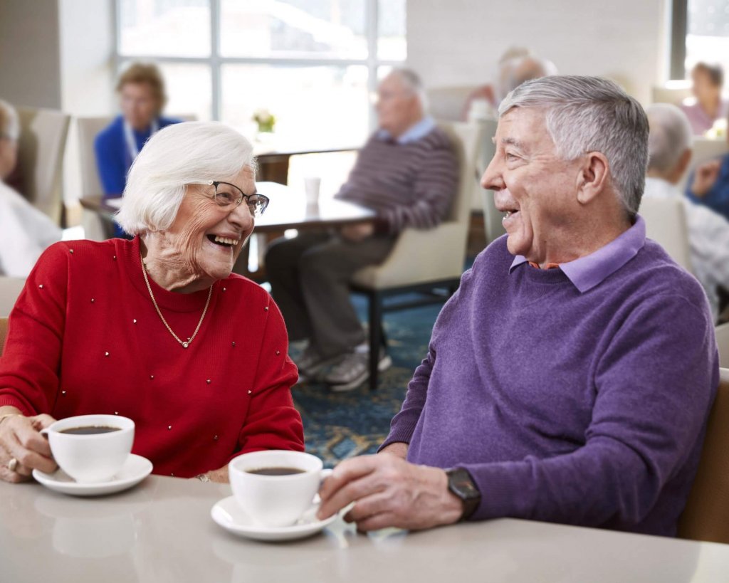 Two residents enjoying a coffee together.